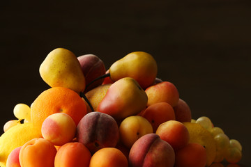 Heap of fresh fruits on dark background