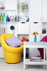 White living room with armchairs and bookcase