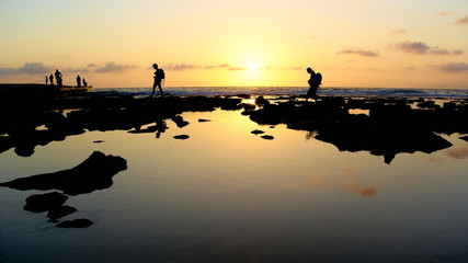walking,cliff,sunset,backlight,silhouette