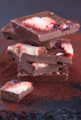 Stack of chocolate slices strawberry on a dark background.