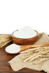 Wheat flour in bowl on wooden table isolated on white