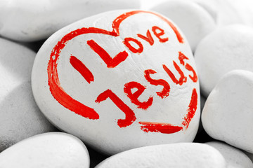 Pebbles with inscription I LOVE JESUS, closeup