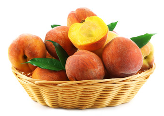 Ripe peaches in basket isolated on white