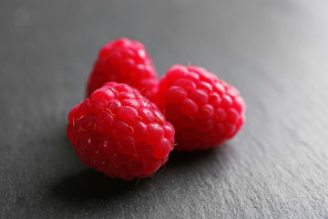 Fresh red raspberries on wooden background