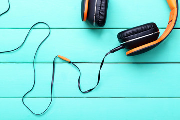 Headphones on wooden background