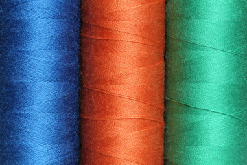 Three spools of color polyester threads