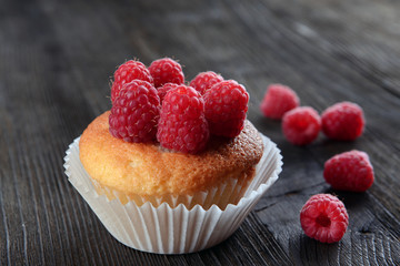Delicious cupcake with berries on wooden table close up