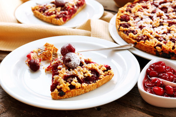 Tasty homemade pie with cherries on table close up