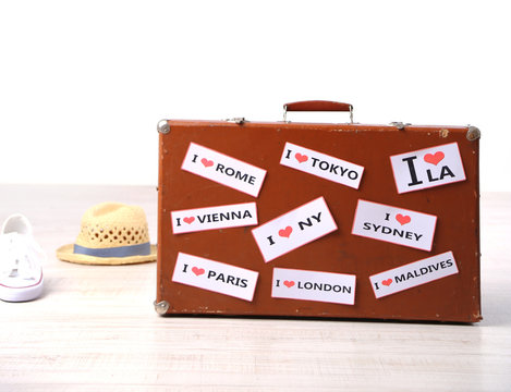 Suitcase with stickers on floor in room