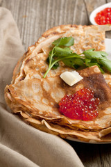 Red caviar on pancakes