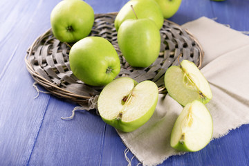Sliced green apple on wooden table, closeup