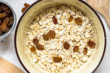 Cup of oatmeal with raisins on the table