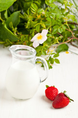 Obraz na płótnie Canvas Tow fresh strawberries with milk