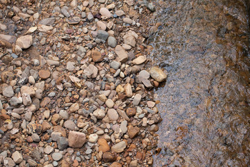 river stone, texture of mixed size of pebbles by the river shore