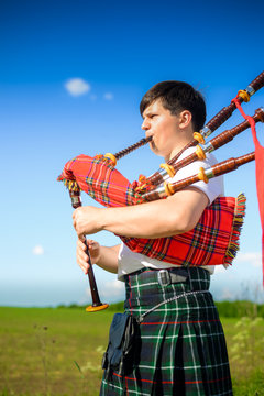 Picture of man enjoying playing pipes in Scottish traditional