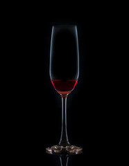 Red wine in a glass isolated on black background