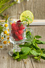 Fresh ripe raspberries and camomile flowers
