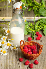 Fresh ripe raspberries and milk