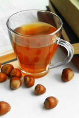Cup of tea with stack of books on windowsill, closeup