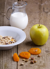 Breakfast with muesli, milk and apple