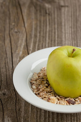 Plate of muesli with green apple