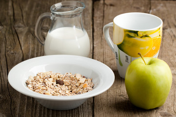 Breakfast with muesli, milk and apple