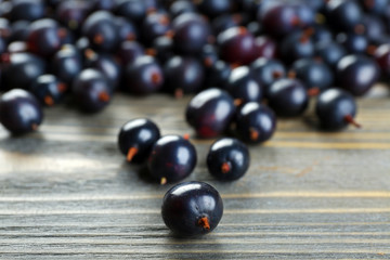 Heap of wild black currant on wooden table close up