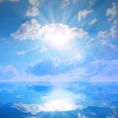 Sunny sky with clouds above a water level. Nature background.