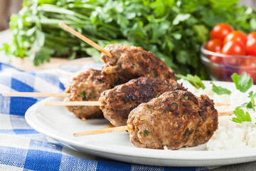 Barbecued kofta with rice on a plate