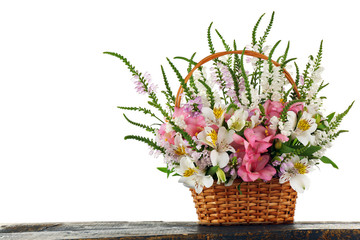 Beautiful floral arrangement in basket isolated on white