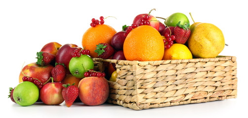 Fototapeta na wymiar Heap of fresh fruits and berries in basket isolated on white