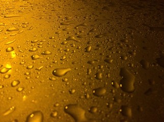 Fototapeta na wymiar Raindrops in golden light