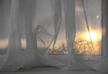 Sunset through curtain.