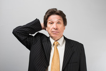 man holding his hand on his head