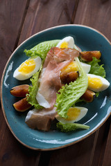 Salad with ham, fresh figs and eggs. Closeup, selective focus