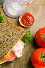 Fresh sandwich with ham, onion and tomato