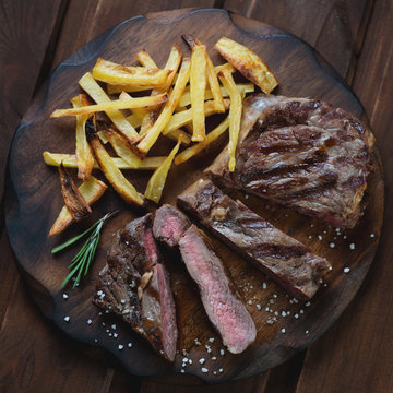 Above View Of Sliced Medium Grilled Ribeye Steak With Potato