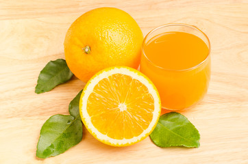 Fototapeta na wymiar Navel orange fruit and juice on wooden background
