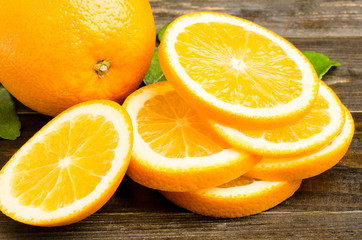 Fototapeta na wymiar Slice of Navel orange fruit on wooden background