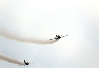 historic warplane with dark smoke from the engine malfunction
