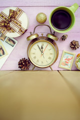 Closeup of coffee cup, alarm clock and christmas decorations on