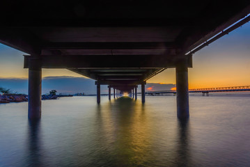 sunset in the sea and transport bridge