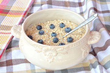 Bowl of fine oat flakes with fresh fruit