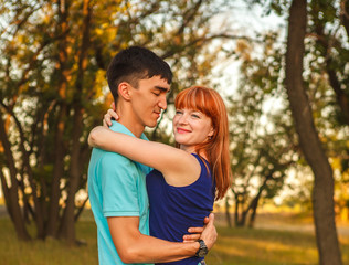 Fototapeta premium Young couple hugging in forest outdoors