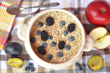 Bowl of fine oat flakes with fresh fruit