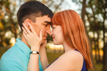 Young couple hugging in forest outdoors