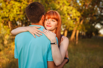 Young couple hugging in forest outdoors