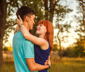 Young couple hugging in forest outdoors
