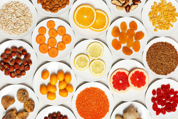 Set of orange products on wooden table, closeup