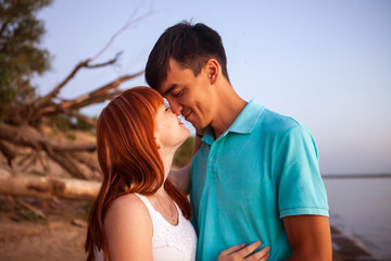 Fototapeta premium young couple looking in one direction, the distance in the park,